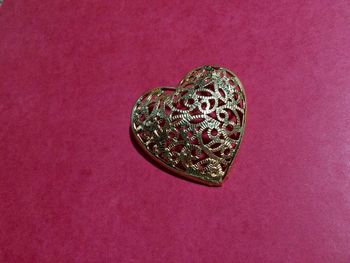 Close-up of heart shape against pink background