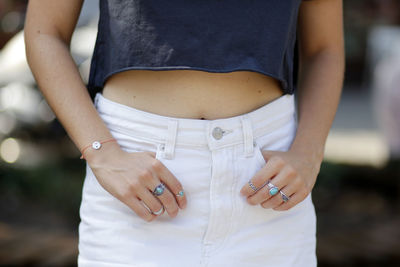 Midsection of woman wearing finger rings