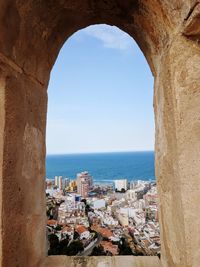 Sea seen through arch of building