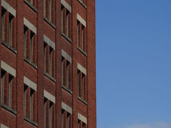 Low angle view of buildings against clear blue sky