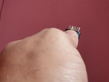 Close-up of human hand against red background