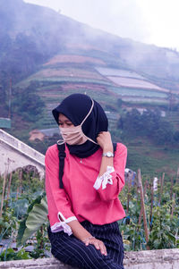 Woman wearing mask when traveled to nature like a mountain