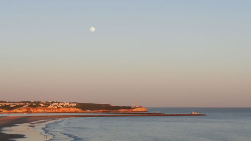 Scenic view of sea against clear sky during sunset