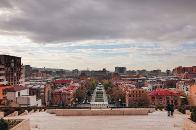 Cityscape against cloudy sky