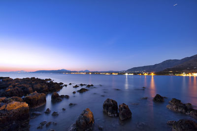 Scenic view of sea against clear blue sky