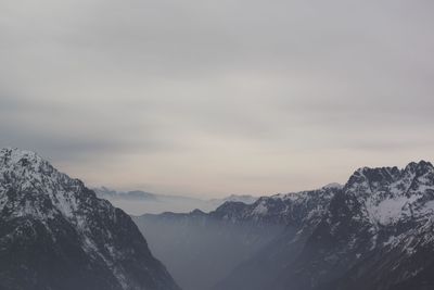 Scenic view of mountains against cloudy sky