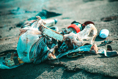 Close-up of abandoned garbage on field