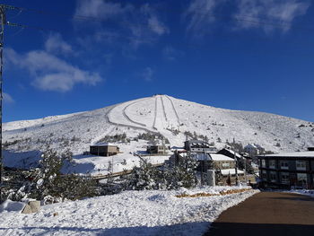 Houses against snowcapped mountain against sky