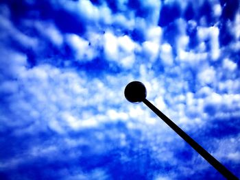 Low angle view of street light against blue sky