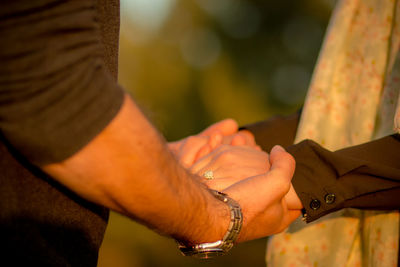 Close-up of couple holding hands