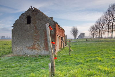 Old building on field against sky