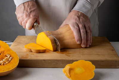 Midsection of man preparing food on table