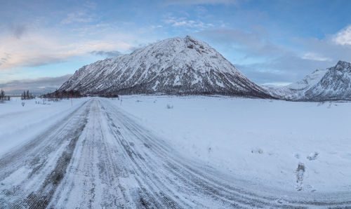 Panoramic view of snow covered landscape against sky