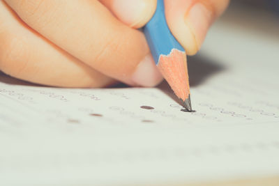 Close-up of hand holding paper