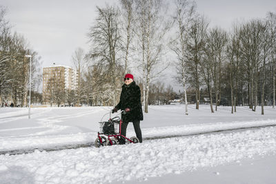 Rear view of man on snow field against sky