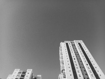 Low angle view of modern buildings against clear sky