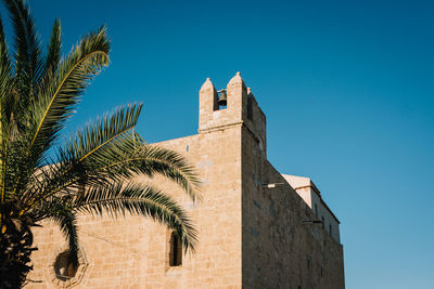 Low angle view of building against clear blue sky