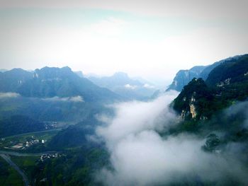 Scenic view of mountains against cloudy sky