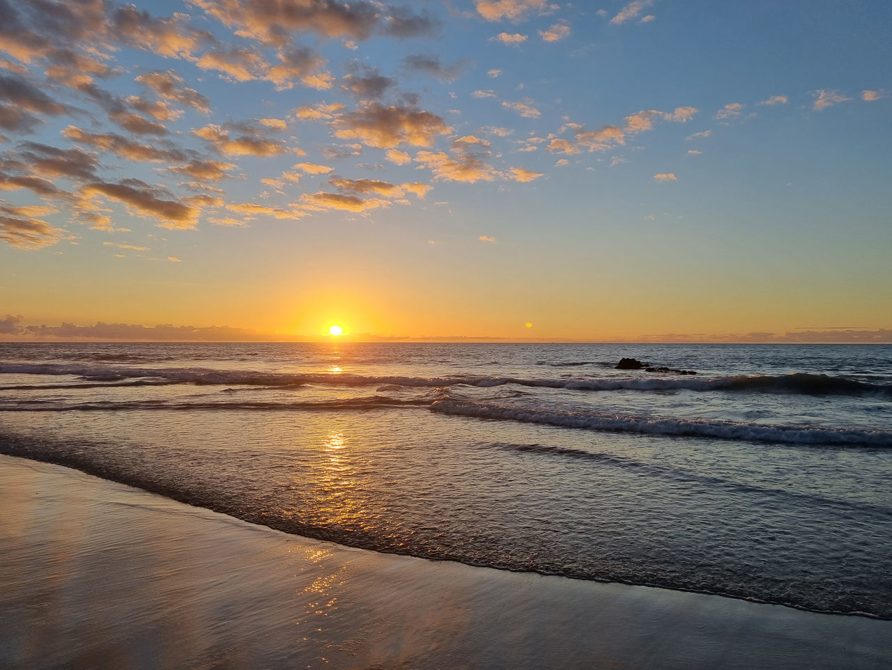 sky, water, sea, sunset, beauty in nature, scenics - nature, land, beach, tranquility, nature, horizon over water, tranquil scene, horizon, cloud, shore, ocean, sunlight, sun, reflection, dawn, idyllic, wave, no people, orange color, sand, coast, seascape, outdoors, dramatic sky, body of water, travel destinations, environment, motion, wind wave, evening, travel, landscape, afterglow, holiday, non-urban scene