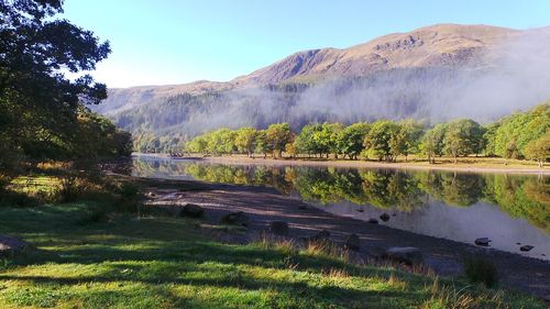 Scenic view of lake and mountains against sky