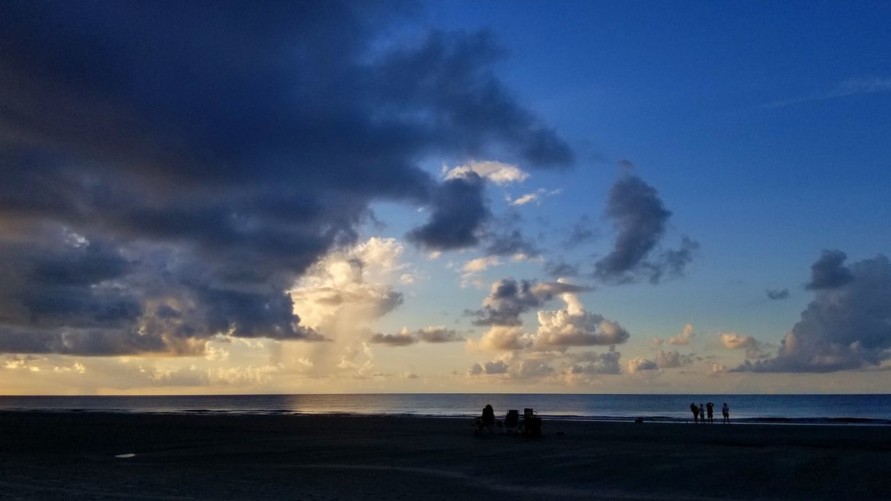 PANORAMIC VIEW OF SILHOUETTE PEOPLE ON BEACH AGAINST SKY DURING SUNSET
