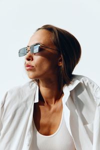 Portrait of young woman against white background