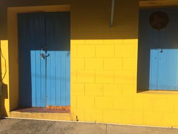 Closed door of yellow wall