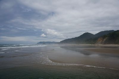 Scenic view of beach and mountain