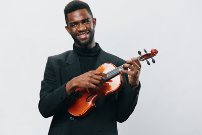 Man playing violin against white background