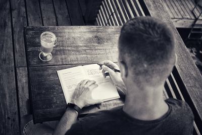 High angle view of man drinking glasses on table