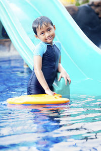 Portrait of boy in water slide