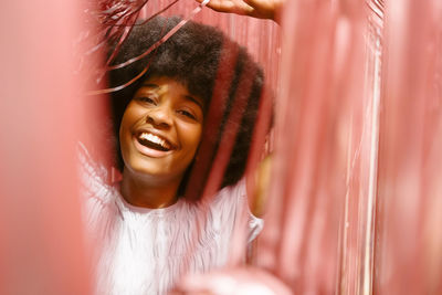 Cheerful young woman amidst tinsels enjoying party