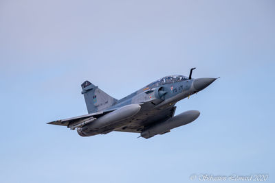 Low angle view of airplane flying against clear sky