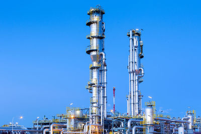 View of a gas refinery plant illuminated at dusk.