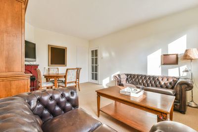 Empty chairs and table against wall at home