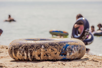 Close-up of abandoned tire on sand