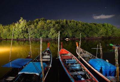 Boats moored in lake against sky