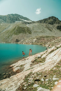 People on mountain against sky