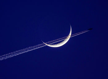 Low angle view of airplane flying against clear sky