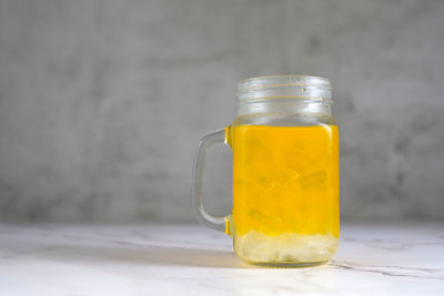 Close-up of drink in glass jar on table