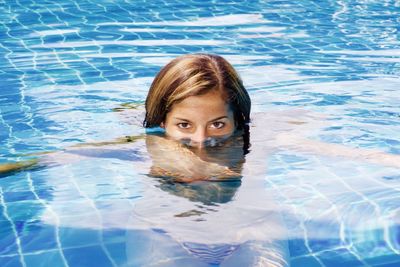 Portrait of woman swimming in pool