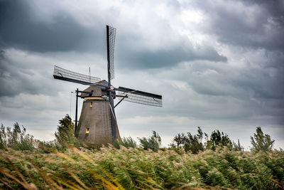 Low angle view of traditional windmill against sky