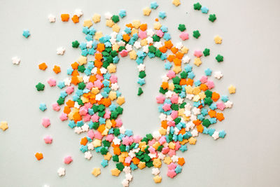 High angle view of multi colored candies on white background