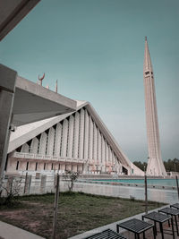 Low angle view of bridge and buildings against sky