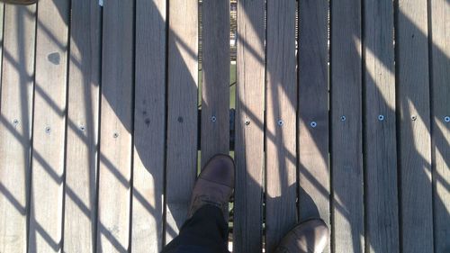 Low section of person on wooden floor