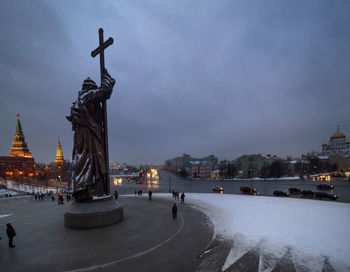Statue in city at night