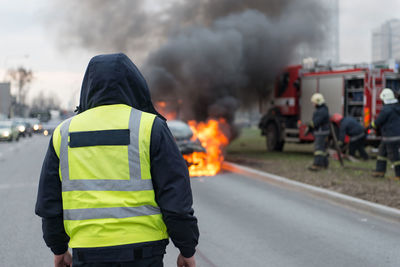 Rear view of firefighter on street