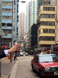 Cars on street by buildings in city