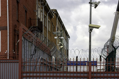 Low angle view of street light against buildings