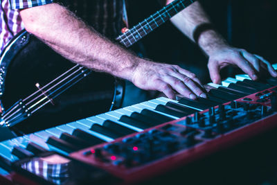 Midsection of man playing guitar